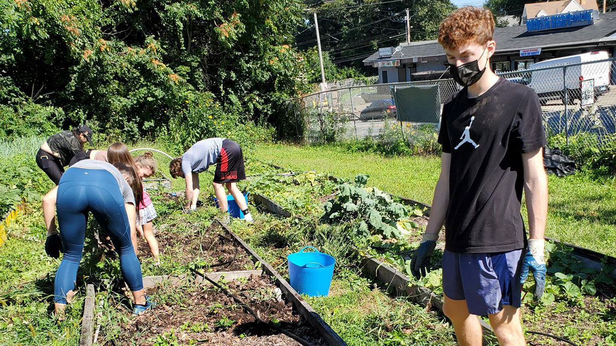 SHU-WELL students volunteer at the Reservoir Community Farm in Bridgeport.