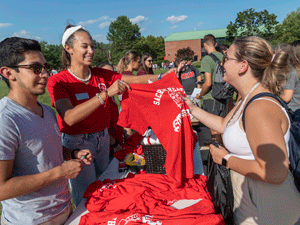 Orientation leaders passing out t-shirts during Welcome Week