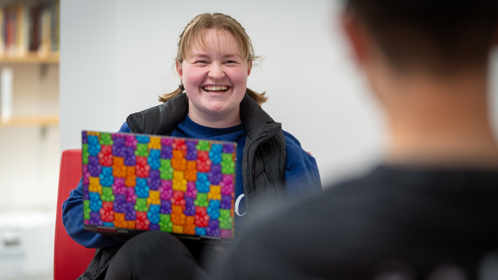Student smiling with laptop