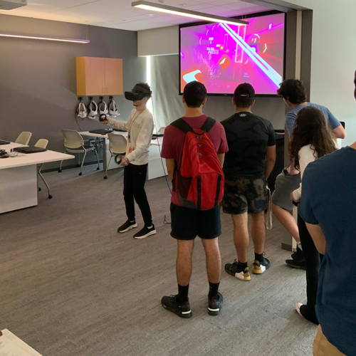 Students watching student use VR