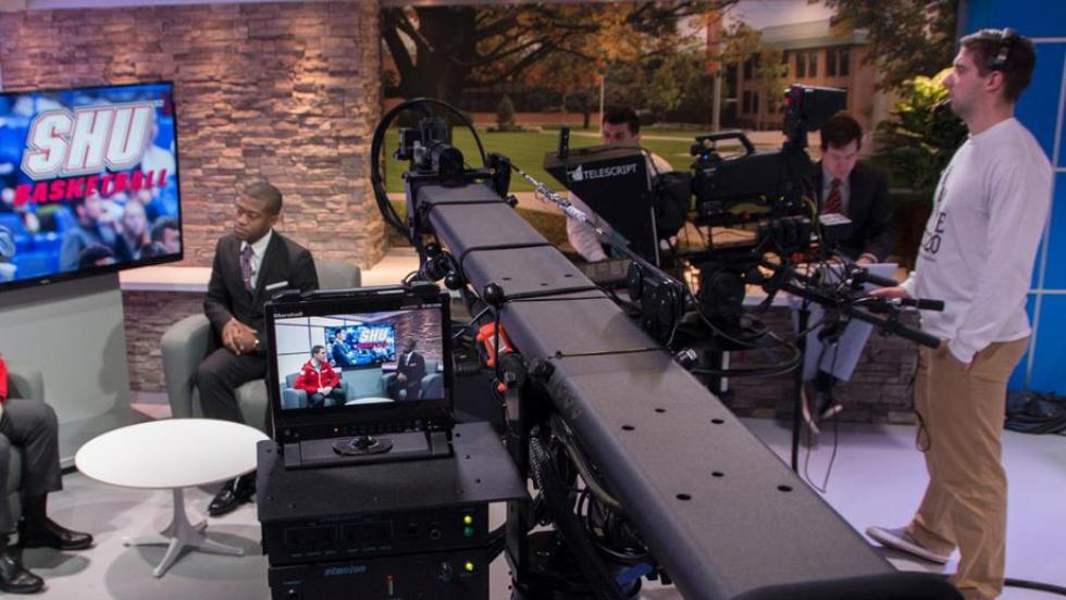 Students filming an interview on set
