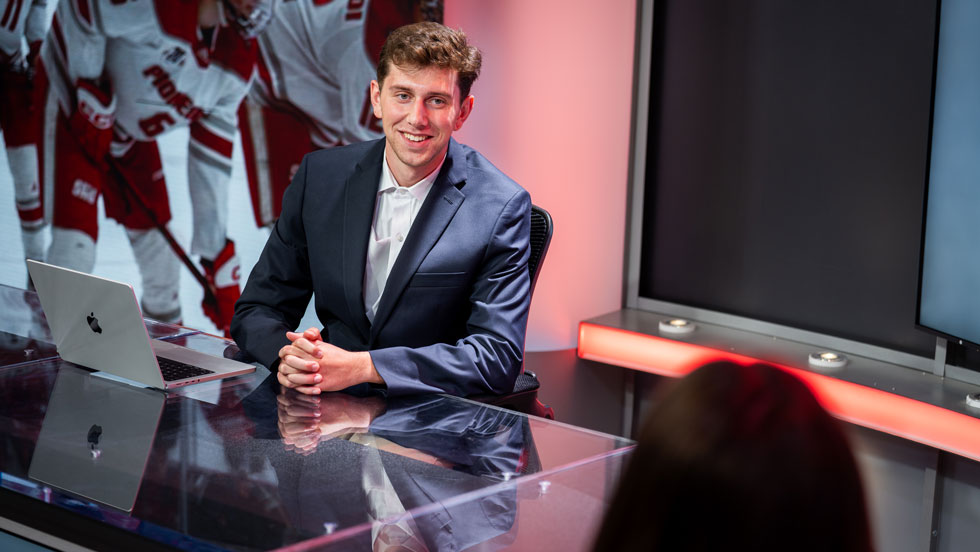 Student sitting at reporting desk
