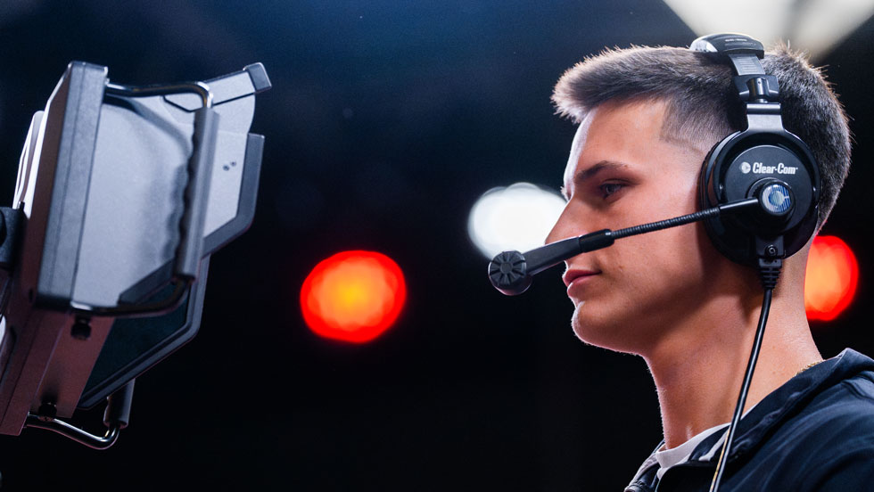 Student filming with headset on