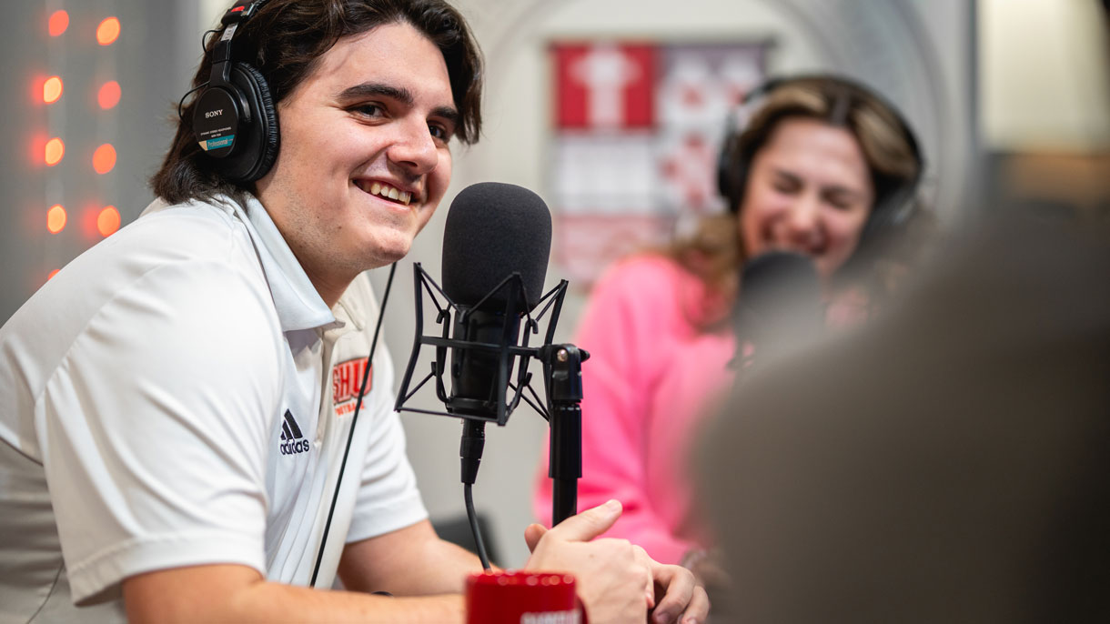 Students talking into microphones in studio