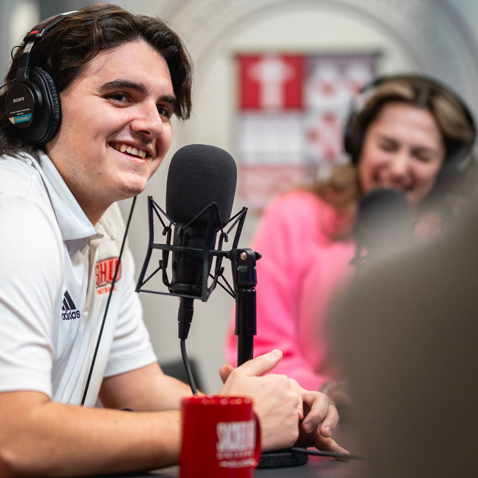 Students talking into microphones in studio