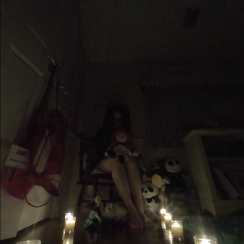 Doll sitting in a dark room
