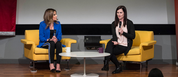 Two women speaking on stage