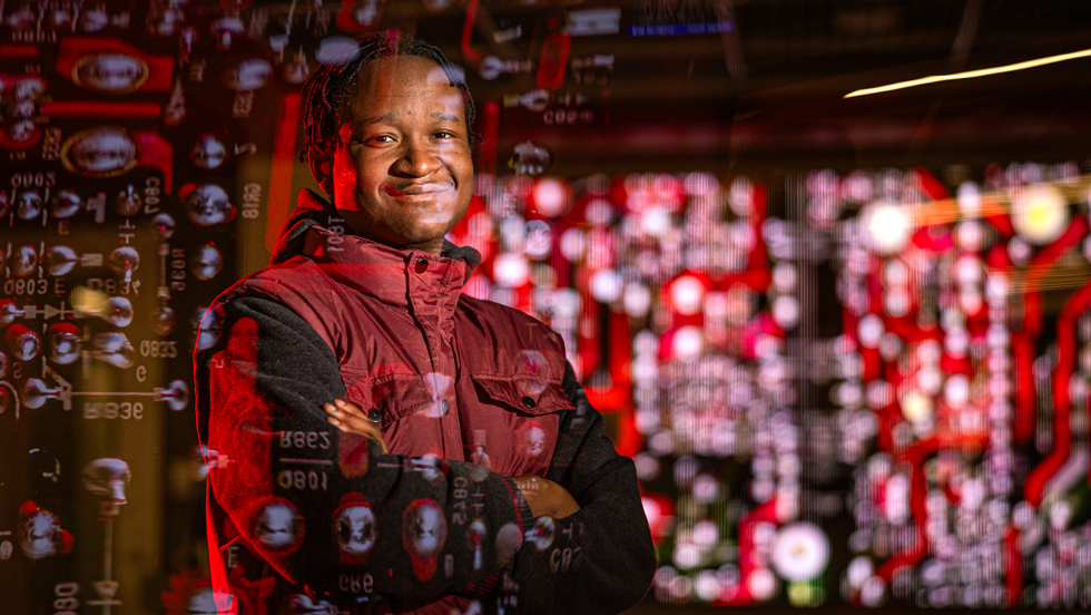 Cybersecurity student with computer code over photo