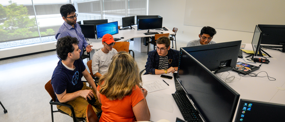 Students and professor working in the Cybersecurity Lab