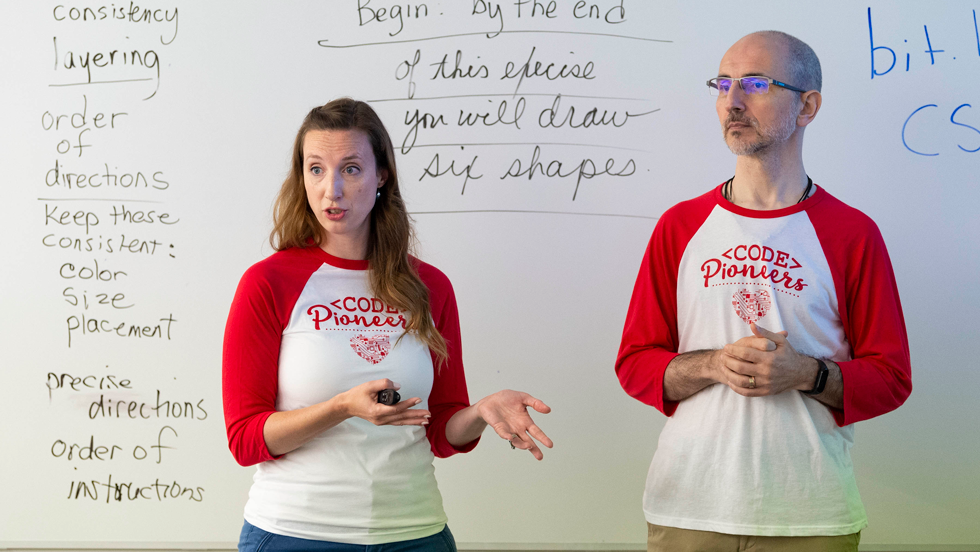 Computer science professors speaking to a class