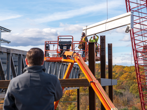 Man watching construction workers
