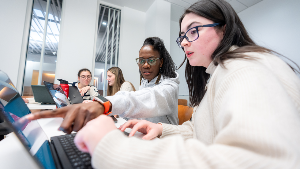Students in class working on laptops
