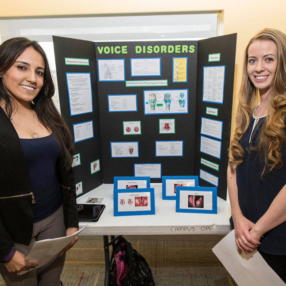 two students giving a presentation 