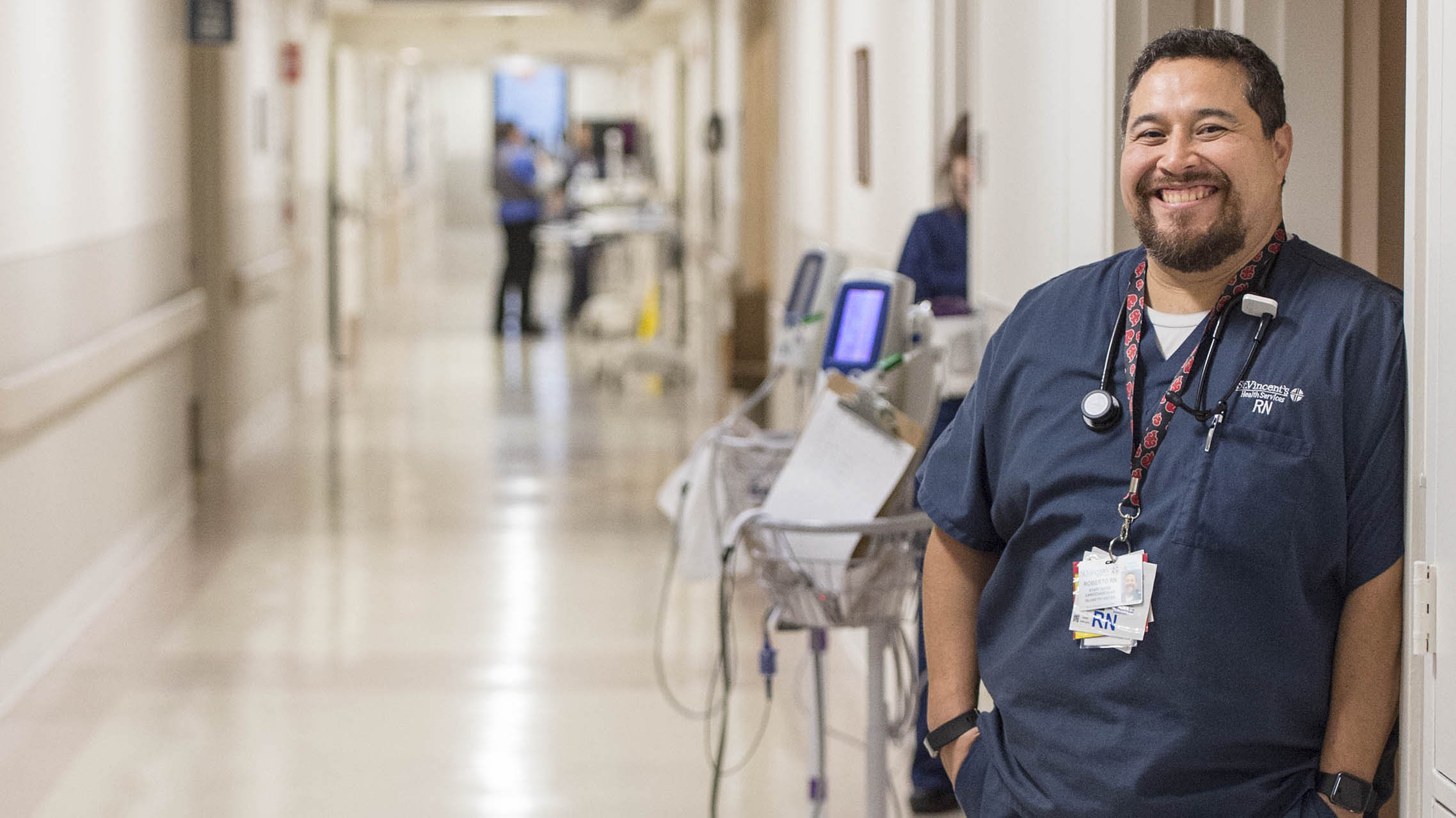 Male nurse standing in hallway