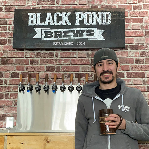 Alumnus smiling in brewery