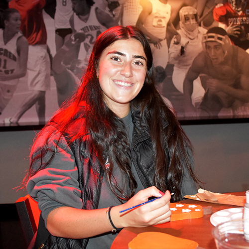 person painting a pumpkin