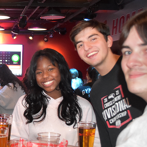 friends smiling together at a pub