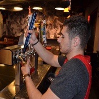 John Sullivan pouring beer