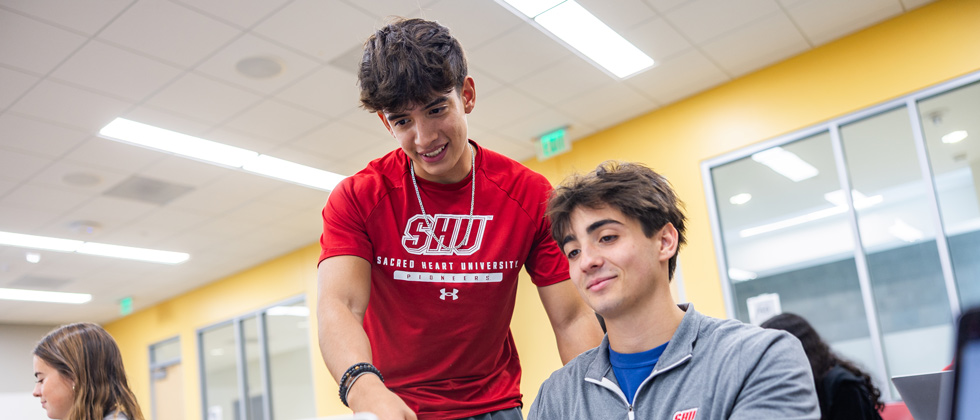 Two students looking at a computer