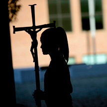 Student holding cross