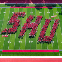 Aerial view of students spelling out SHU on campus field