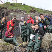 Group of students on a rocky cliff in Dingle, Ireland