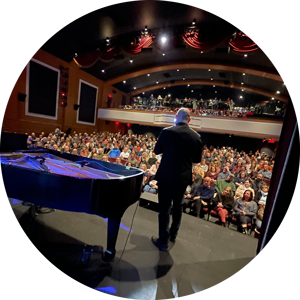 Man on stage with crowd in background