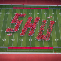 Aerial view of students spelling out SHU on campus field