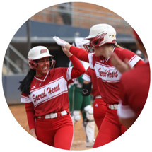 Softball players celebrating