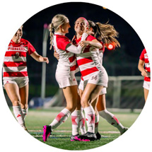 Soccer players hugging and celebrating