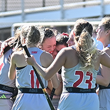 a field hockey team celebrating