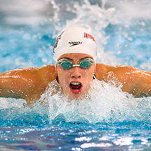 a swimmer doing the butterfly stroke in competition