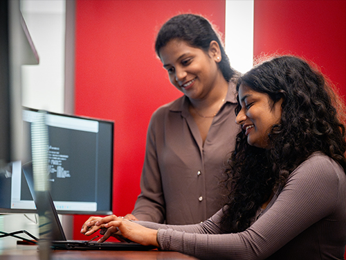 two people looking at a computer